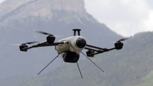 TO GO WITH AFP STORY BY ESTELLE EMONET A drone of the Delta drone company flies over the Chartreuse Range as it is operated by an intern during a training session on June 20, 2013 in Quaix-en-Chartreuse near Grenoble, eastern France. Delta drone is one of France's leaders in the drone sector for civil purpose. AFP PHOTO/PHILIPPE DESMAZES